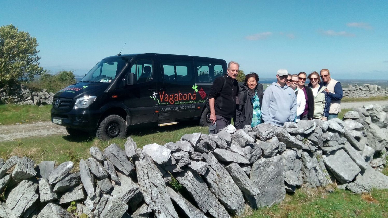 Vagabond group behind a dry stone wall in the Burren, Clare