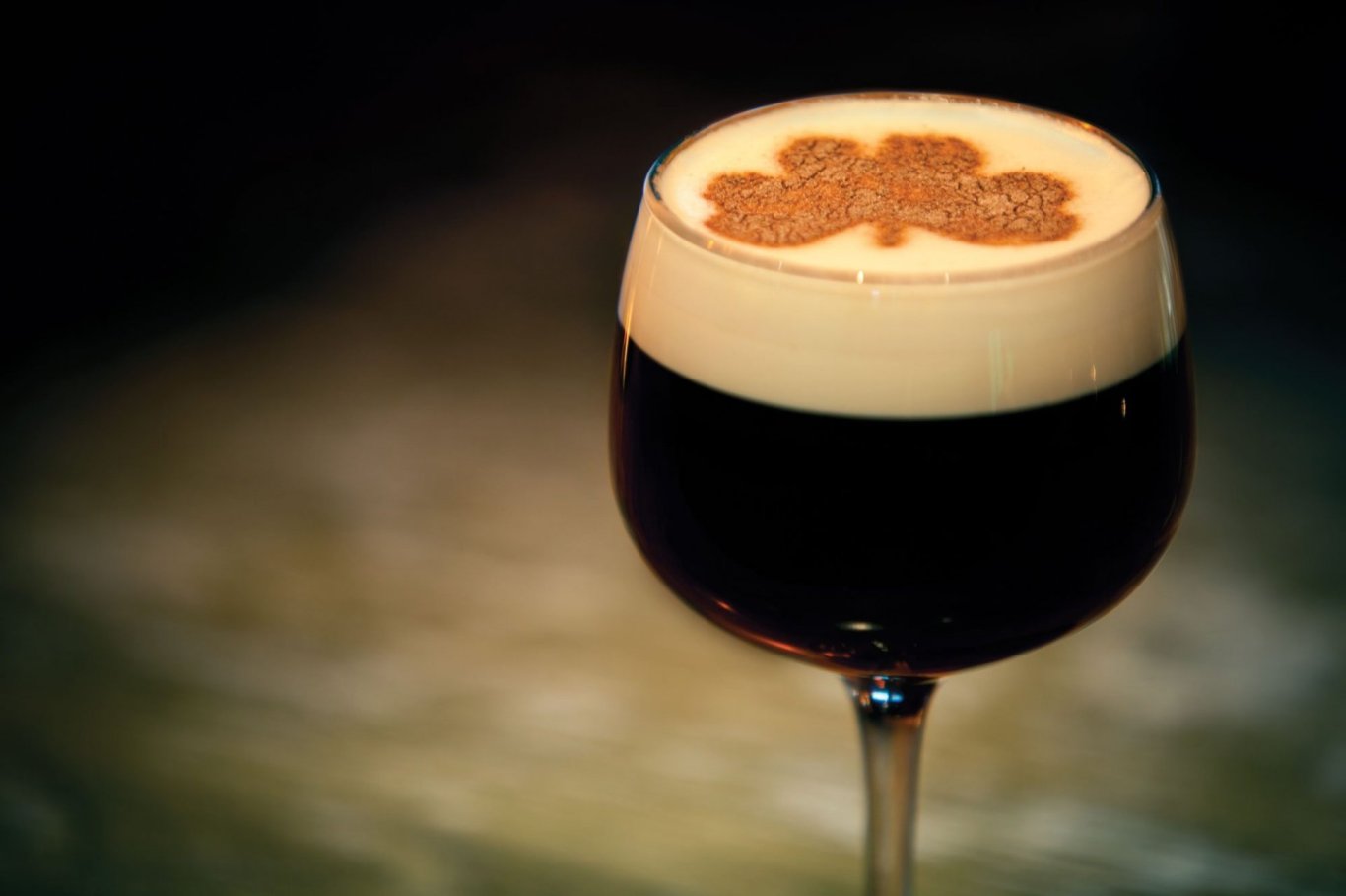 Irish coffee in a glass with shamrock on top