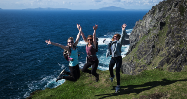 A trio of Vagabond guests jumping on the Irish coastline