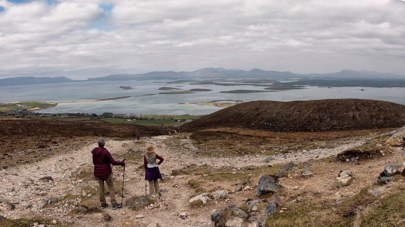 Two climbers enjoy the view from Croagh Patrick over Clew Bay