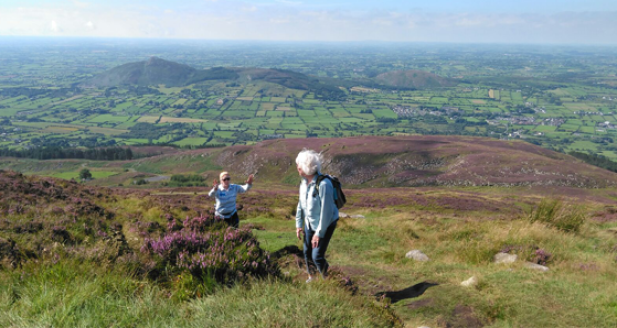 12 Day Ginat Irish Adevnture tour guests; Catherine and Monika climb Slieve Gullion