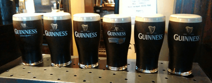 A line of Guinness pints