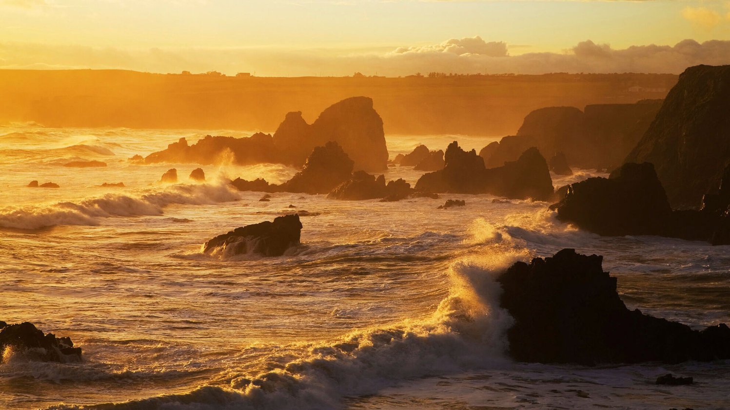 Evening light catches waves on Waterford's Copper Coast