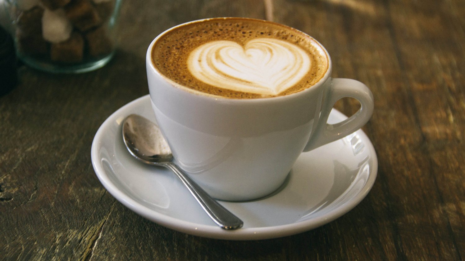 A heart shape in foamed milk on top of a barista coffee